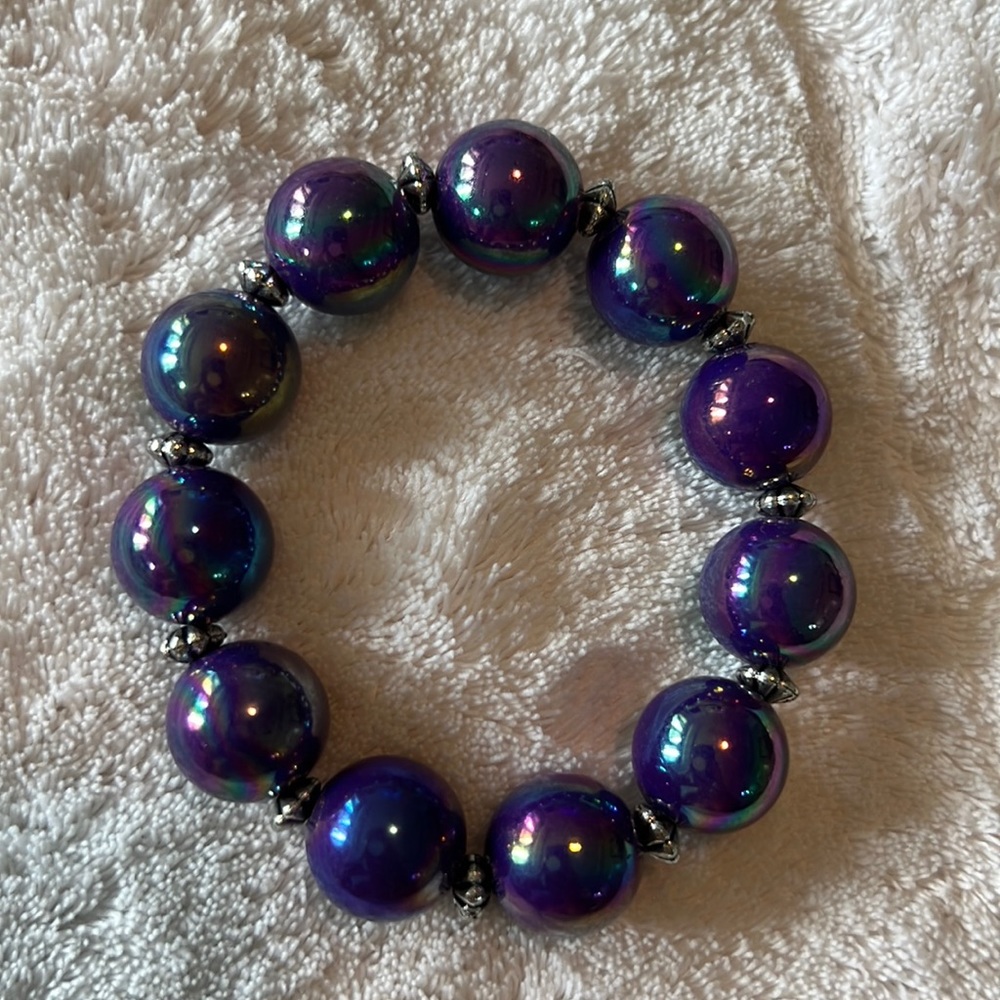 Garold Miller stretch bracelet with silver separators. Incandescent purple